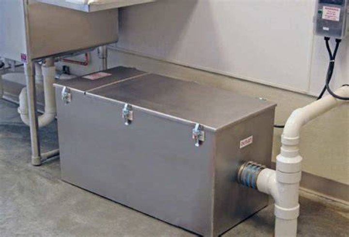 How do restaurants clean grease traps?